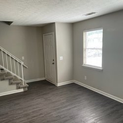 living room with wood floors bathroom at Creekview Apartments Located in Scottdale, Georgia