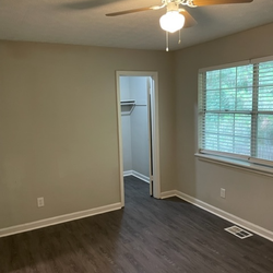 bedroom with wood floors bathroom at Creekview Apartments Located in Scottdale, Georgia 3