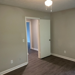 bedroom with wood floors at Creekview Apartments Located in Scottdale, Georgia