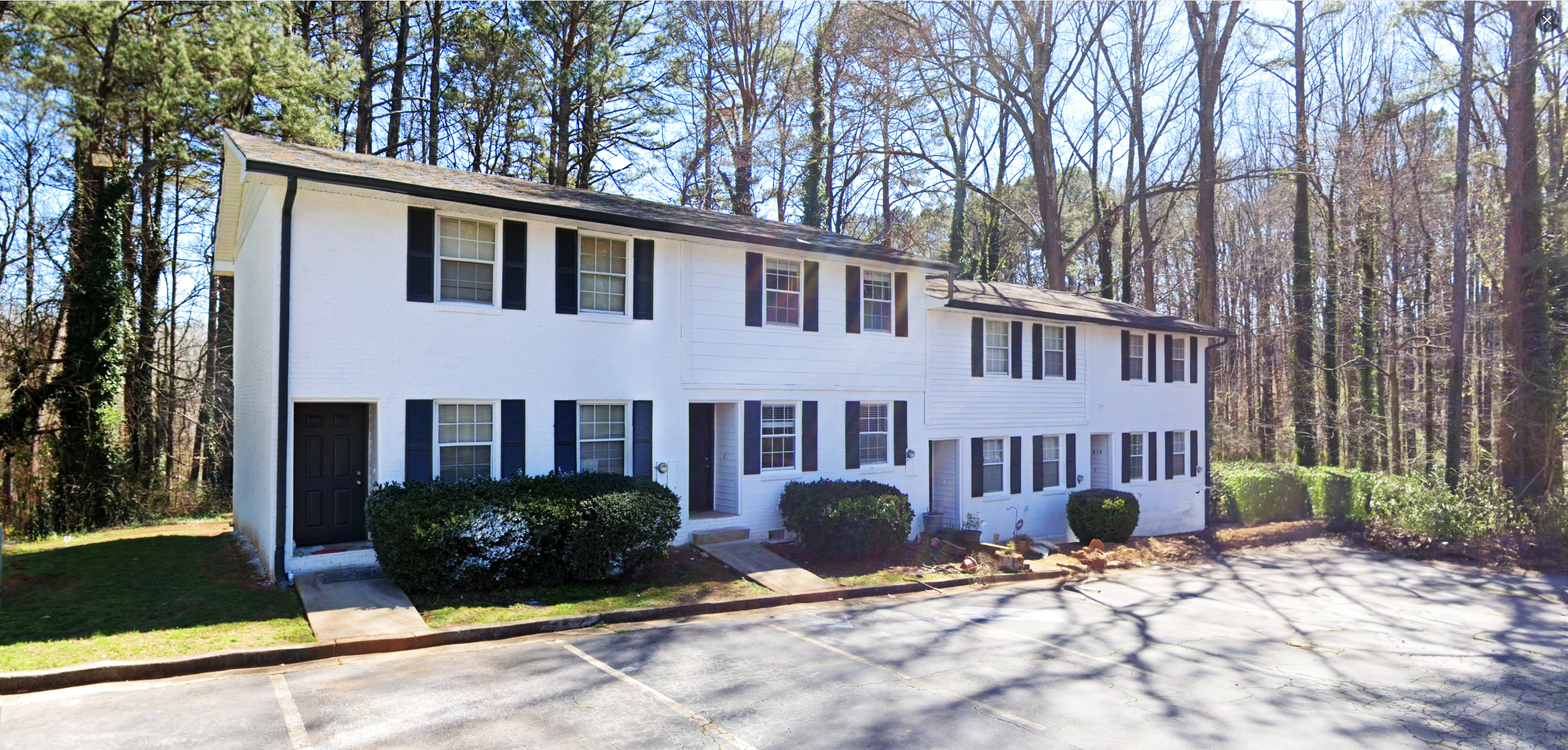 Exterior view of Creekview Apartments with beautiful landscaping, located in Scottsdale, GA